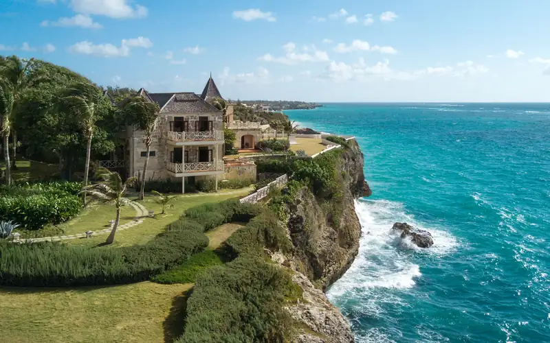 Stunning coastline of Barbados featuring white sandy beaches and crystal clear waters under a blue sky