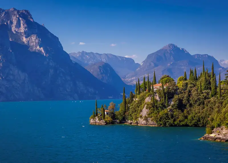 Breathtaking scenery of Lake Garda in Italy featuring clear blue waters and lush green hills